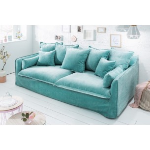 Canapé moderne en velour coloris bleu aqua avec des coussins
