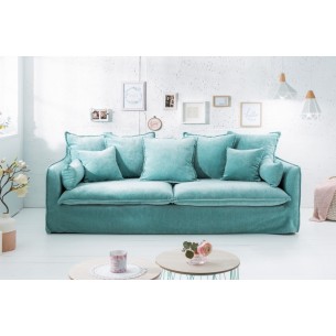 Canapé moderne en velour coloris bleu aqua avec des coussins